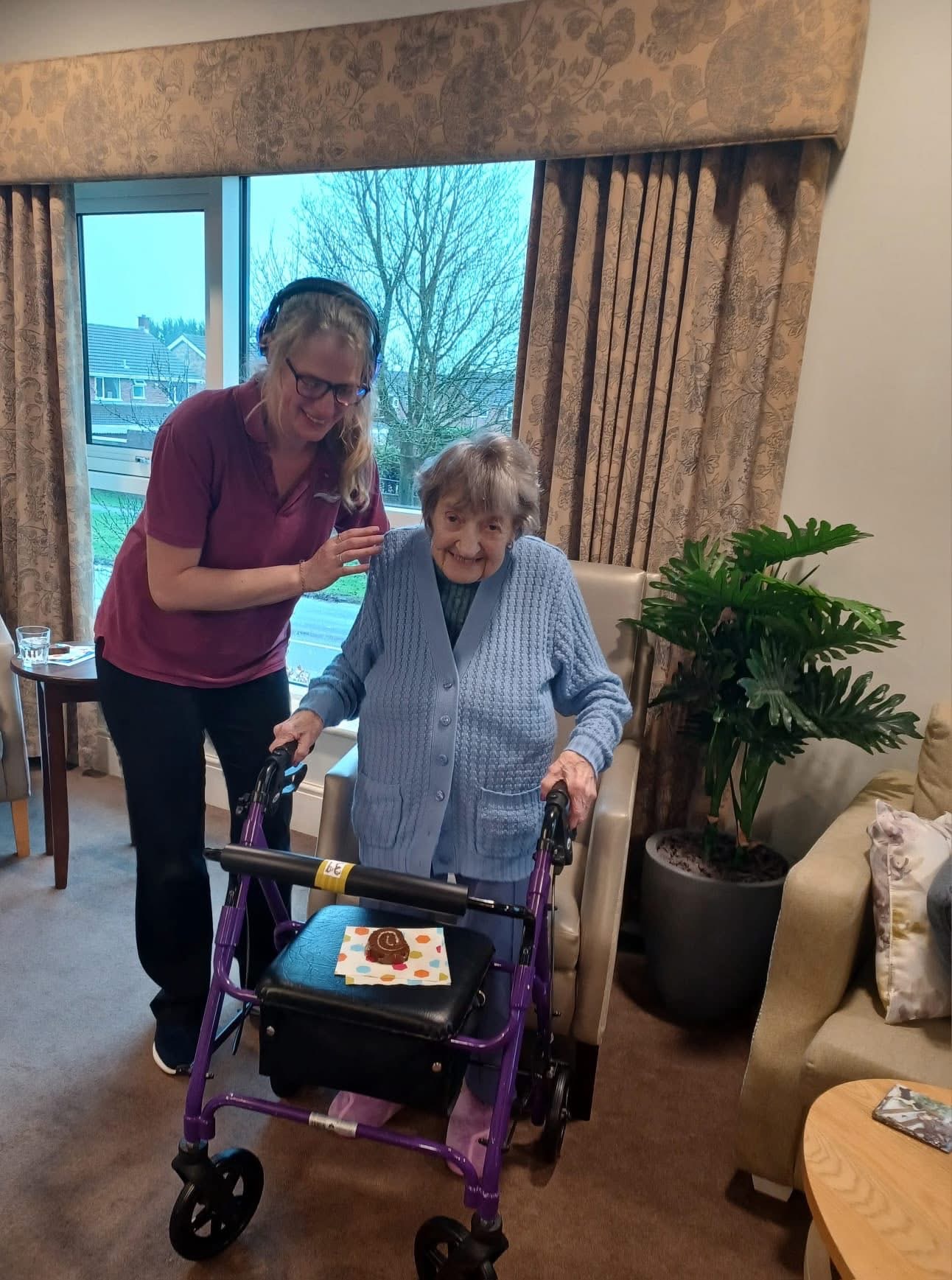 A Severn Physiotherapy therapist supporting a client with her walking frame